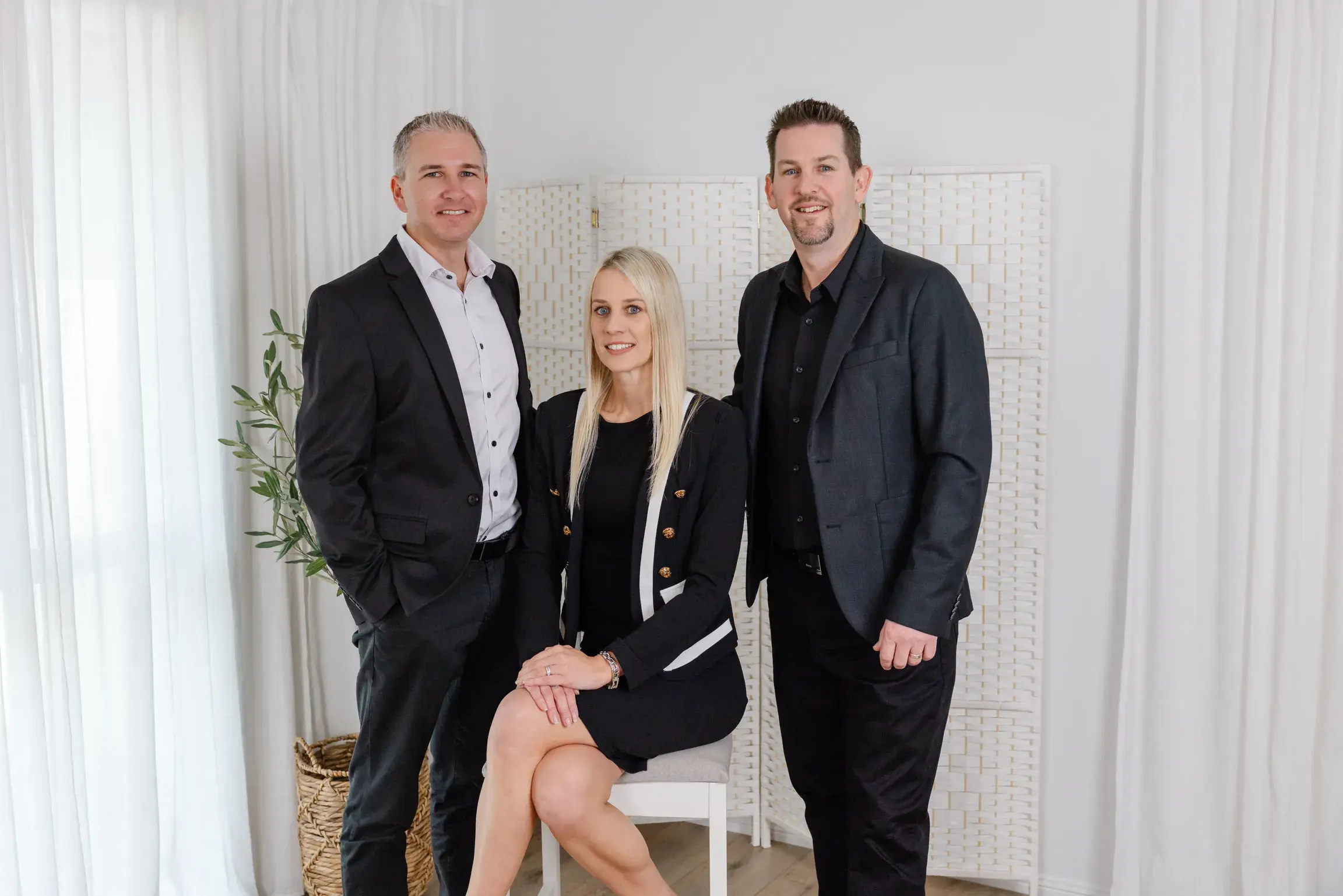 Jayden and Mathew standing either side of Belinda, seated, in the Touch Residential studio